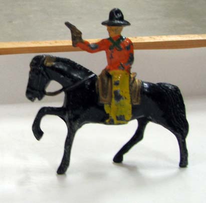 a%20lead%20painted%20toy%20figure%20of%20a%20mounted%20cowboy%20holding%20a%20gun